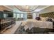 Spacious main bedroom with a luxurious bed, coffered ceiling, and stylish decor at 4891 Tarry Post Ln, Suwanee, GA 30024