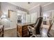 This office features a designer desk and chair and has an entrance to the dining room and bath at 4891 Tarry Post Ln, Suwanee, GA 30024