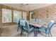 Covered brick patio featuring outdoor dining area, ideal for entertaining at 4891 Tarry Post Ln, Suwanee, GA 30024