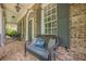 Charming front porch featuring brick floor, bench seating, and classic details at 4891 Tarry Post Ln, Suwanee, GA 30024