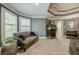 Cozy sitting area with tufted settee and decorative pillows at 4891 Tarry Post Ln, Suwanee, GA 30024