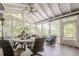 Bright sunroom featuring vaulted ceilings, ceiling fan, and surrounded by windows with natural light at 4891 Tarry Post Ln, Suwanee, GA 30024