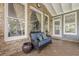 Inviting sunroom with wicker seating and a brick accent wall at 4891 Tarry Post Ln, Suwanee, GA 30024