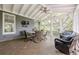 Relaxing screened porch with comfortable seating, tile floors, and wooded views at 4891 Tarry Post Ln, Suwanee, GA 30024