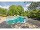 Backyard swimming pool surrounded by lush greenery, lounge chairs, and landscaped areas at 4891 Tarry Post Ln, Suwanee, GA 30024