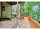 Spacious back deck with sturdy support beams, providing an ideal spot for relaxation and enjoying nature at 5020 Huntshire Sw Ln, Lilburn, GA 30047