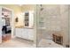 Beautiful bathroom featuring a tiled walk-in shower, double vanity, and view to the main bedroom at 5020 Huntshire Sw Ln, Lilburn, GA 30047