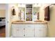Elegant bathroom featuring a dual sink granite vanity and separate storage unit at 5020 Huntshire Sw Ln, Lilburn, GA 30047