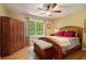 Charming bedroom features hardwood floors, a ceiling fan and a wardrobe at 5020 Huntshire Sw Ln, Lilburn, GA 30047