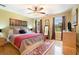 Cozy bedroom featuring hardwood floors, a ceiling fan and lots of natural light at 5020 Huntshire Sw Ln, Lilburn, GA 30047