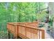 Multi-level deck with lush greenery, perfect for outdoor enjoyment and relaxation in a wooded setting at 5020 Huntshire Sw Ln, Lilburn, GA 30047