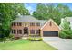 Charming brick home with well-manicured lawn and mature trees offering great curb appeal at 5020 Huntshire Sw Ln, Lilburn, GA 30047