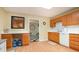 Functional kitchen with bright wood cabinets, white countertops, and a view into another room at 5020 Huntshire Sw Ln, Lilburn, GA 30047