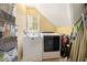 Convenient laundry room with a washer, dryer, and a window providing natural light at 5020 Huntshire Sw Ln, Lilburn, GA 30047