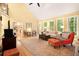 Open living room with hardwood floors, fireplace, and large windows, creating a welcoming atmosphere at 5020 Huntshire Sw Ln, Lilburn, GA 30047