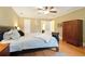 Comfortable main bedroom with ceiling fan, hardwood floors and en-suite bathroom access at 5020 Huntshire Sw Ln, Lilburn, GA 30047
