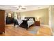 Spacious main bedroom featuring hardwood floors, a ceiling fan and ample natural light at 5020 Huntshire Sw Ln, Lilburn, GA 30047