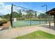Well-maintained community tennis court surrounded by fencing and lush greenery at 5020 Huntshire Sw Ln, Lilburn, GA 30047