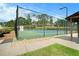 Community tennis court featuring a well-maintained court surface, enclosed for recreational sports and fitness at 5020 Huntshire Sw Ln, Lilburn, GA 30047