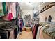 Large walk-in closet with extensive built-in storage and hardwood floors at 5020 Huntshire Sw Ln, Lilburn, GA 30047