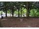 Well-maintained dog park with mulch ground cover and seating nestled among mature trees at 115 W Peachtree Nw Pl # 709, Atlanta, GA 30313