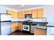 Efficient kitchen boasts stainless appliances, light wood cabinets, and sleek countertops at 115 W Peachtree Nw Pl # 709, Atlanta, GA 30313