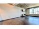 Modern living area featuring concrete ceilings and floors along with large window at 115 W Peachtree Nw Pl # 709, Atlanta, GA 30313