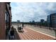 Outdoor patio with brick flooring, black railings, skyline view and patio furniture at 115 W Peachtree Nw Pl # 709, Atlanta, GA 30313