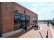 Outdoor patio with brick flooring, large windows, black railings and patio furniture at 115 W Peachtree Nw Pl # 709, Atlanta, GA 30313
