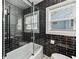 Modern bathroom showcasing black subway tile, a glass-enclosed shower, and contemporary fixtures for a sleek look at 2106 Penrose Dr, Atlanta, GA 30344