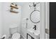 Contemporary powder room featuring a floating sink, modern fixtures, and decorative wall shelves at 2106 Penrose Dr, Atlanta, GA 30344