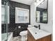 Modern bathroom features black subway tile, stylish fixtures, and ample natural light, creating a sleek and inviting space at 2106 Penrose Dr, Atlanta, GA 30344