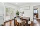 Bright dining area features hardwood floors, white chairs, a table, and French doors leading to the outside at 2106 Penrose Dr, Atlanta, GA 30344