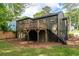 Rear exterior of home featuring deck, stairs, and well-maintained lawn at 2106 Penrose Dr, Atlanta, GA 30344