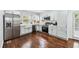 This updated kitchen offers modern appliances, light blue cabinets and hardwood floors, offering a blend of style and function at 2106 Penrose Dr, Atlanta, GA 30344