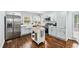 Bright kitchen features stainless steel appliances, light blue cabinets and a functional kitchen island at 2106 Penrose Dr, Atlanta, GA 30344