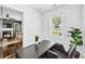Cozy home office with a large desk, a comfortable chair, and a glimpse into a living area with a fireplace at 2106 Penrose Dr, Atlanta, GA 30344