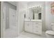 Clean bathroom boasts white tile, vanity with drawers, cabinets and lighting fixture at 4555 Peachtree Dunwoody Rd, Sandy Springs, GA 30342