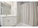 Updated bathroom featuring a white vanity with white countertop and patterned shower curtain at 4555 Peachtree Dunwoody Rd, Sandy Springs, GA 30342