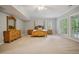 Spacious bedroom featuring natural light, neutral carpet, and a charming four-poster bed at 4555 Peachtree Dunwoody Rd, Sandy Springs, GA 30342