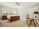 Comfortable bedroom features a ceiling fan, carpet, and a glass-topped desk at 4555 Peachtree Dunwoody Rd, Sandy Springs, GA 30342