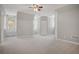 Large, bright room features neutral walls and carpet with window seat and ceiling fan at 4555 Peachtree Dunwoody Rd, Sandy Springs, GA 30342