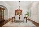 Elegant dining room featuring a wood table, chandelier, and dark hardwood floors at 4555 Peachtree Dunwoody Rd, Sandy Springs, GA 30342