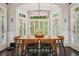 Charming dining room with large windows, wood table, chandelier, and hardwood floors at 4555 Peachtree Dunwoody Rd, Sandy Springs, GA 30342