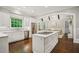 Bright, modern kitchen with white cabinets, marble countertops, and stainless steel appliances at 4555 Peachtree Dunwoody Rd, Sandy Springs, GA 30342