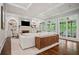 Bright living room with fireplace, built-in bookshelves, and coffered ceiling at 4555 Peachtree Dunwoody Rd, Sandy Springs, GA 30342