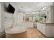 Luxurious main bathroom featuring a soaking tub, granite countertops, and ample cabinet space at 4555 Peachtree Dunwoody Rd, Sandy Springs, GA 30342