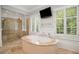Elegant main bathroom with a soaking tub, a glass shower, and bright natural lighting at 4555 Peachtree Dunwoody Rd, Sandy Springs, GA 30342