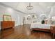 Spacious main bedroom features tray ceilings, hardwood floors, a fireplace, and built-in shelving at 4555 Peachtree Dunwoody Rd, Sandy Springs, GA 30342