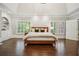Serene main bedroom with hardwood floors, tray ceiling, and large windows offering abundant natural light at 4555 Peachtree Dunwoody Rd, Sandy Springs, GA 30342